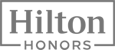 The image displays the "Hilton Honors" logo, showcasing the branding of the Hilton loyalty program in grayscale.