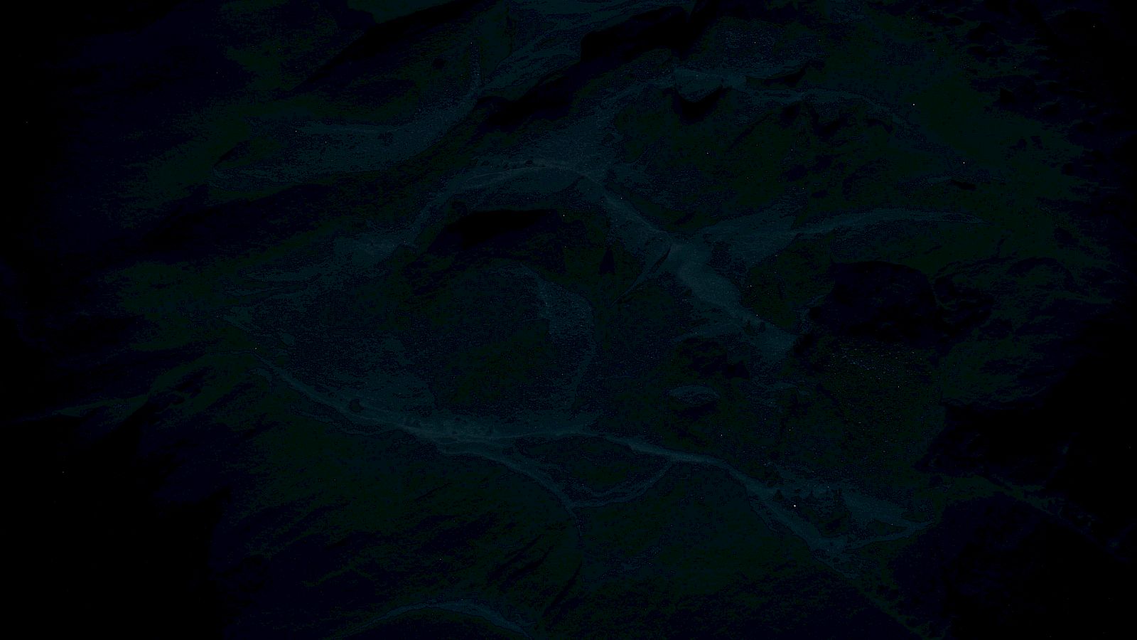 The image appears dark and indistinct with vague shapes, possibly due to poor lighting or underexposure, making it hard to discern details.