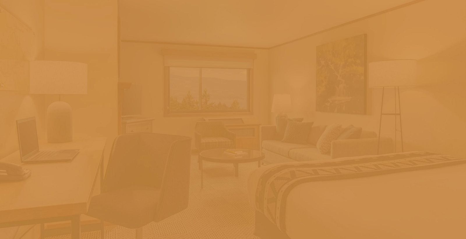 The image shows a cozy hotel room with a bed, desk, chairs, and a window with a view of trees and mountains. Warm lighting sets a relaxing tone.