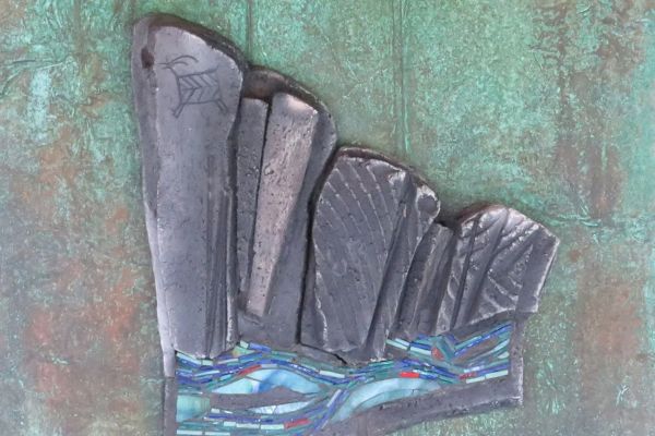 The image shows a textured artwork featuring abstract shapes over a green background, possibly resembling rocks and water.