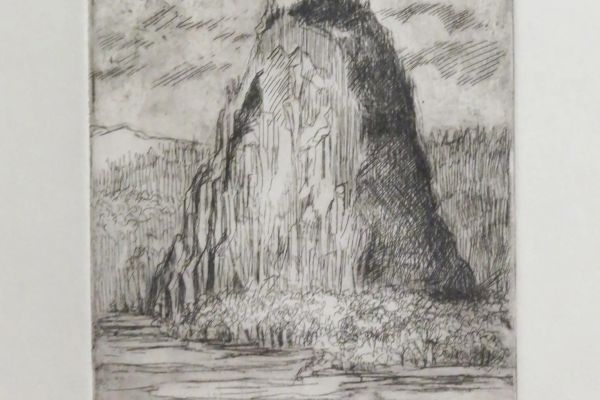 The image shows an etching of a steep rock formation surrounded by water, with clouds above. The style is detailed and monochromatic.
